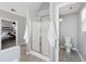 Bright bathroom featuring a glass shower and a glimpse into the bedroom with a large bed at 400 Mirramont Ln, Woodstock, GA 30189