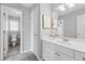 Bright bathroom features a white vanity and a glimpse into the adjacent toilet room at 400 Mirramont Ln, Woodstock, GA 30189