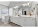 Large bathroom features a double vanity, soaking tub, and ample natural light at 400 Mirramont Ln, Woodstock, GA 30189