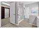 Open-concept bathroom with tile floors, glass shower and a walk-in closet at 400 Mirramont Ln, Woodstock, GA 30189