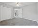 Comfortable bedroom with ceiling fan, double door closet and grey carpet flooring at 400 Mirramont Ln, Woodstock, GA 30189