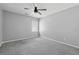 Neutral bedroom has light gray walls, a ceiling fan, and a window at 400 Mirramont Ln, Woodstock, GA 30189