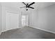 Comfortable bedroom features a closet, ceiling fan and grey carpet flooring at 400 Mirramont Ln, Woodstock, GA 30189