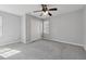 Spacious bedroom with ample natural light, ceiling fan, and carpet floors at 400 Mirramont Ln, Woodstock, GA 30189