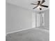 Spacious bedroom with ample natural light, ceiling fan, and carpet floors at 400 Mirramont Ln, Woodstock, GA 30189