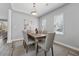 Elegant dining room with modern lighting, neutral walls, and seating for six at 400 Mirramont Ln, Woodstock, GA 30189