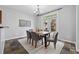 Bright dining room with slate floors, backyard access, modern light fixture, and gray chairs at 400 Mirramont Ln, Woodstock, GA 30189