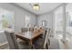 Cozy dining room featuring a rustic wood table, neutral decor, and ample natural light at 400 Mirramont Ln, Woodstock, GA 30189