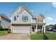 Charming two-story home with a brick-accented garage and well-manicured lawn at 400 Mirramont Ln, Woodstock, GA 30189