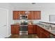 Well-equipped kitchen featuring stainless steel appliances and wooden cabinetry at 400 Mirramont Ln, Woodstock, GA 30189
