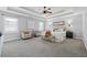 Spacious main bedroom features a tray ceiling, ceiling fan and sitting area at 400 Mirramont Ln, Woodstock, GA 30189