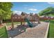 Community playground area with wooden playset, swings, and a green slide at 400 Mirramont Ln, Woodstock, GA 30189