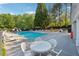 Community pool features various seating options and lush green trees at 400 Mirramont Ln, Woodstock, GA 30189