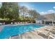 Community pool with lounge chairs, tables, and well-maintained landscaping at 400 Mirramont Ln, Woodstock, GA 30189