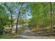 Gravel walking path leading to the lake surrounded by beautiful trees at 400 Mirramont Ln, Woodstock, GA 30189