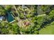 Bird's-eye view of the house surrounded by green trees, located near a lake with a swimming pool at 6515 Namon Wallace Dr, Cumming, GA 30028