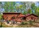 Outdoor patio with furniture on the back of a log home, perfect for relaxing and entertaining at 6515 Namon Wallace Dr, Cumming, GA 30028