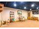 A spacious finished basement features a black drop ceiling, display shelves, and built-in drawers at 6515 Namon Wallace Dr, Cumming, GA 30028