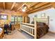 Cozy bedroom with wooden accents, a desk area, and natural light streaming through the windows at 6515 Namon Wallace Dr, Cumming, GA 30028