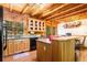 Open kitchen featuring an island, stainless steel appliances, natural wood cabinets, and wood ceiling at 6515 Namon Wallace Dr, Cumming, GA 30028