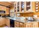 Charming kitchen with wood cabinets, granite countertops, black appliances, and ample storage at 6515 Namon Wallace Dr, Cumming, GA 30028
