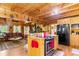 Open-concept kitchen with wood cabinets, stainless appliances, and access to the living area at 6515 Namon Wallace Dr, Cumming, GA 30028