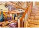 Open-concept layout with wooden accents, a fireplace, and a staircase leading to an upper level at 6515 Namon Wallace Dr, Cumming, GA 30028