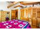 Comfortable main bedroom featuring wooden floors, exposed beams, and ample closet space at 6515 Namon Wallace Dr, Cumming, GA 30028