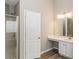 Bright bathroom featuring shower, cabinet, sink, toilet, and new floors at 7503 Garnet Dr, Jonesboro, GA 30236