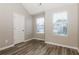 Bedroom with large windows, new vinyl floors, and neutral paint at 7503 Garnet Dr, Jonesboro, GA 30236