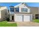 Charming two-story home with a two-car garage and freshly cut lawn at 7503 Garnet Dr, Jonesboro, GA 30236