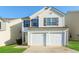 Charming two-story home featuring a two-car garage and well-maintained lawn at 7503 Garnet Dr, Jonesboro, GA 30236