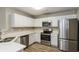 Modern kitchen with stainless steel appliances, and white countertops at 7503 Garnet Dr, Jonesboro, GA 30236