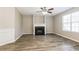 Bright living room features a fireplace, large window, and modern flooring at 7503 Garnet Dr, Jonesboro, GA 30236