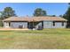 Spacious backyard featuring lush grass, a patio, and a covered seating area at 95 Graystone Dr, Covington, GA 30014