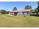 Exterior of house with grass and patio with partial awning, table and grill at 95 Graystone Dr, Covington, GA 30014