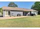 Backyard featuring patio with table and chairs and large lawn at 95 Graystone Dr, Covington, GA 30014
