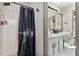 Inviting bathroom featuring a shower with a curtain, dual sinks, and a spacious vanity with storage at 95 Graystone Dr, Covington, GA 30014