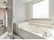Clean bathroom showcasing a soaking tub with elegant fixtures and a window for natural light at 95 Graystone Dr, Covington, GA 30014
