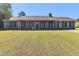 Charming single-story home with a well-manicured lawn and cozy front porch seating at 95 Graystone Dr, Covington, GA 30014