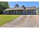 Attractive single-story home featuring a long driveway and well-kept lawn at 95 Graystone Dr, Covington, GA 30014