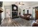 Cozy living room features hardwood floors, a modern fireplace, and ample natural light at 95 Graystone Dr, Covington, GA 30014