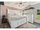 Cozy main bedroom featuring a plush bed, a dresser, and soft natural light from the windows at 95 Graystone Dr, Covington, GA 30014