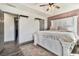 Elegant main bedroom boasts a comfortable bed, an en-suite entry, and stylish decor with wood-look floors at 95 Graystone Dr, Covington, GA 30014