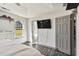 Bright main bedroom showcases an en-suite bathroom, a TV and ample natural light from a window at 95 Graystone Dr, Covington, GA 30014