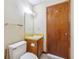 Compact bathroom with a vanity sink and a toilet next to a wooden door at 1735 Little Willeo Rd, Marietta, GA 30068