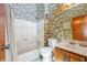 Bathroom with vintage floral wallpaper, shower-tub combination, single sink vanity at 1735 Little Willeo Rd, Marietta, GA 30068