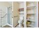 Bathroom with glass enclosed shower, toilet, and shelves for storage at 1735 Little Willeo Rd, Marietta, GA 30068
