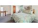 Cozy bedroom features a queen bed with floral patterned bedspread, and scenic art above the headboard at 1735 Little Willeo Rd, Marietta, GA 30068