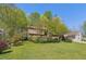 Charming two-story home with a lawn and mature landscaping surrounded by trees providing shade and privacy at 1735 Little Willeo Rd, Marietta, GA 30068
